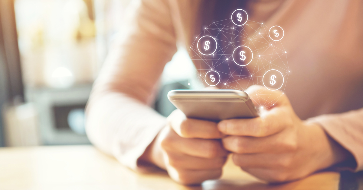Person holding phone with money icons