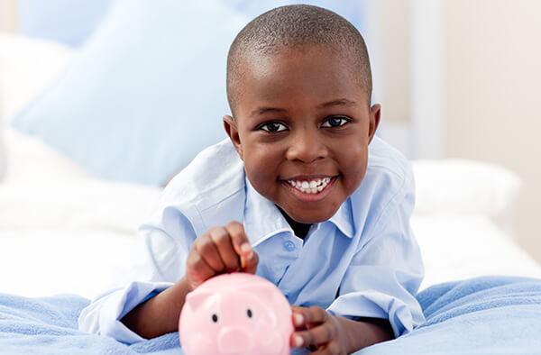 Young boy with piggy bank